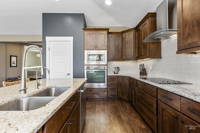 kitchen featuring wall chimney exhaust hood, stainless steel appliances, dark wood-style floors, a sink, and lofted ceiling