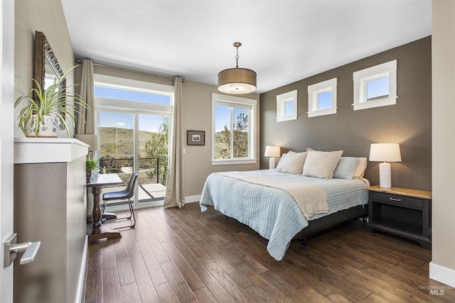 bedroom with baseboards, access to outside, and dark wood-style floors