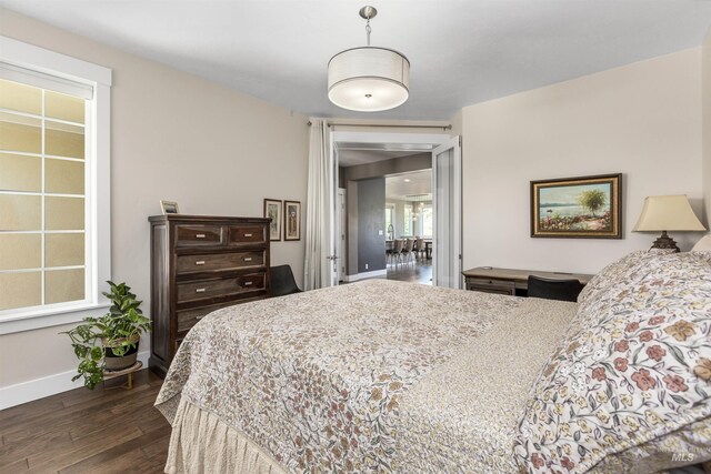 bedroom featuring baseboards and dark wood-style floors