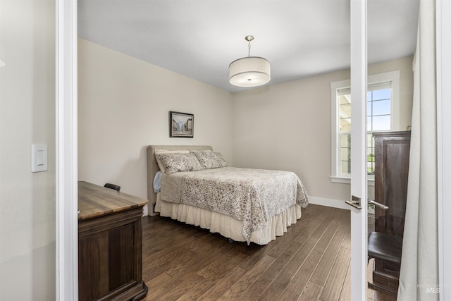 bedroom featuring dark wood-type flooring and baseboards
