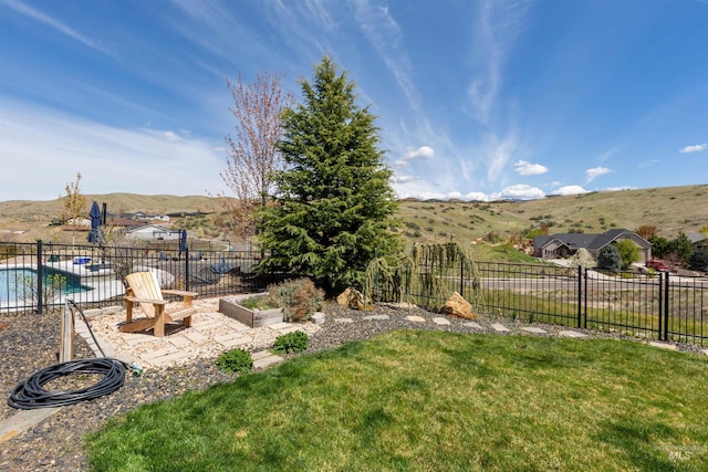 view of yard featuring fence, a fenced in pool, and a mountain view