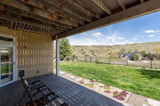 view of patio / terrace with a mountain view and fence