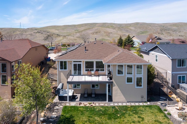 rear view of property with a yard, a patio area, stairs, and stucco siding
