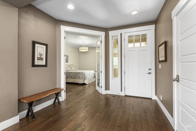 entrance foyer with visible vents, baseboards, recessed lighting, and dark wood finished floors