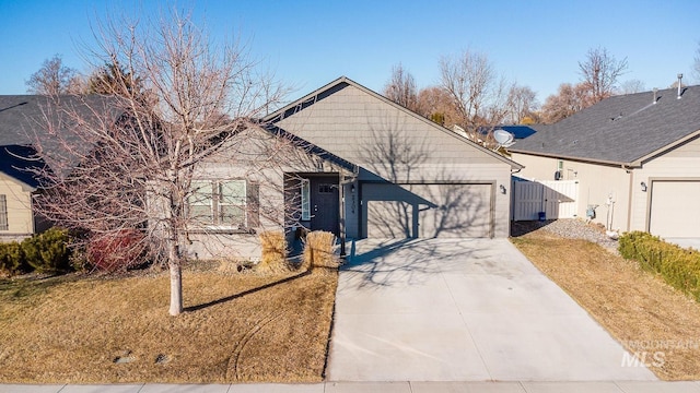 view of front of house with a garage and a front lawn