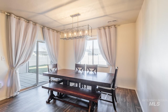 dining space with dark hardwood / wood-style floors