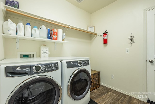 washroom with washing machine and dryer and dark wood-type flooring