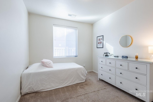 bedroom featuring light colored carpet