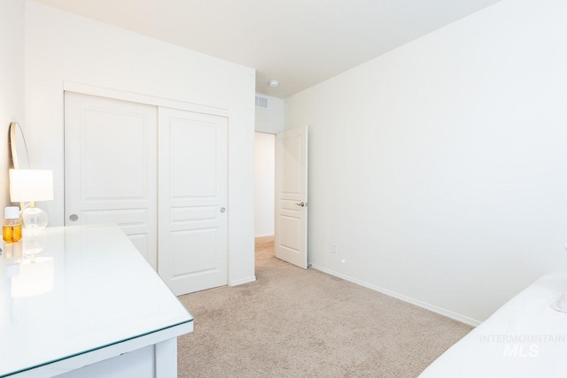 carpeted bedroom featuring a closet