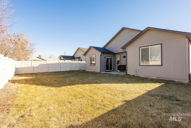 rear view of property featuring a lawn