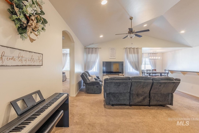 living room with lofted ceiling, light colored carpet, and ceiling fan