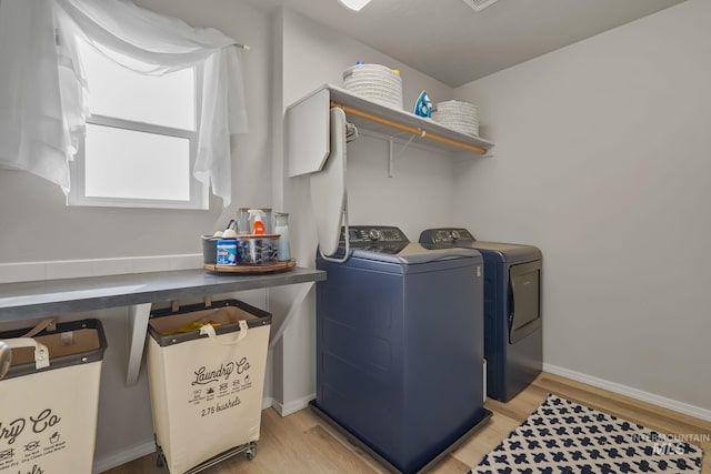 laundry area featuring washer and dryer and light wood-type flooring