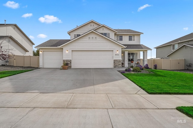 view of front of home featuring a garage, a front lawn, and a porch