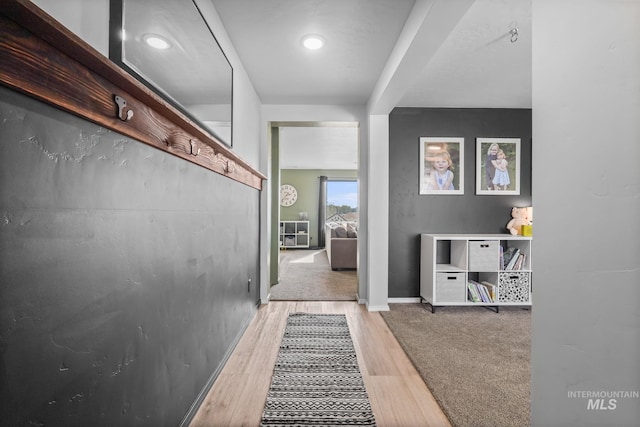 hall with hardwood / wood-style floors