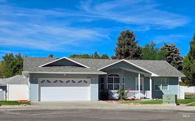 single story home with covered porch and a garage