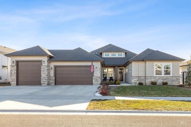 view of front of house featuring a garage and a front lawn