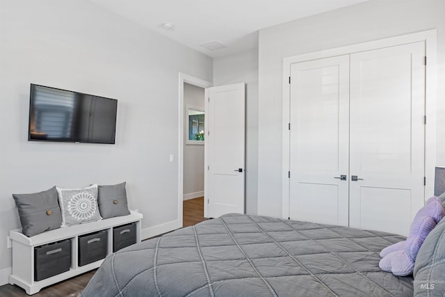 bedroom with hardwood / wood-style floors and a closet