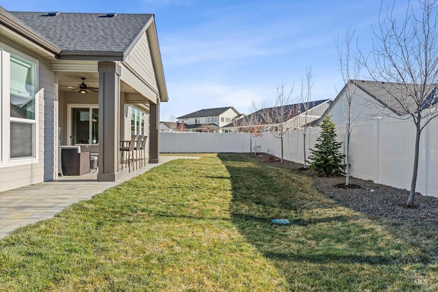 view of yard with ceiling fan and a patio area