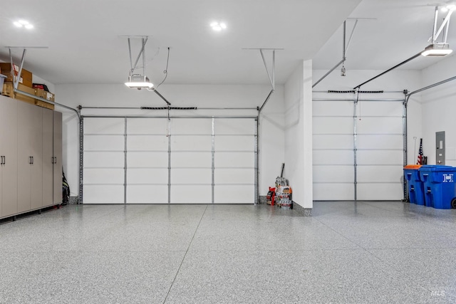 garage with electric panel and a garage door opener