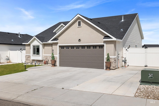 847 Bridget St, Twin Falls, ID 83301 - view of front of home featuring stone siding, stucco siding, a garage, and driveway