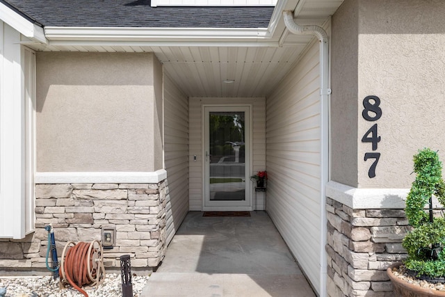847 Bridget St, Twin Falls, ID 83301 - view of exterior entry featuring stone siding, roof with shingles, and stucco siding