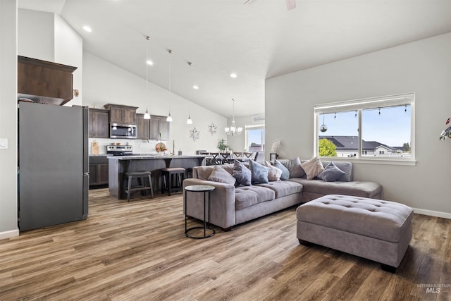 847 Bridget St, Twin Falls, ID 83301 - living area featuring light wood-type flooring, high vaulted ceiling, recessed lighting, ceiling fan, and a chandelier