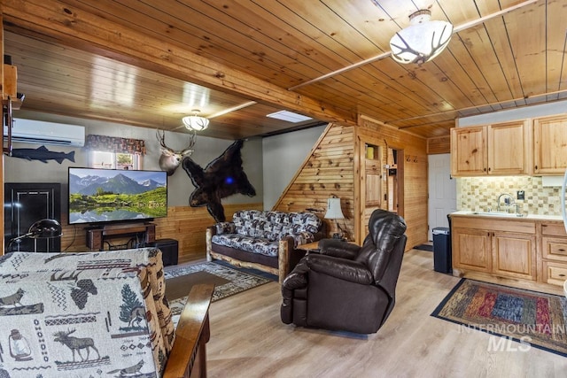 living room with light wood-type flooring, a wall unit AC, wooden walls, and wooden ceiling