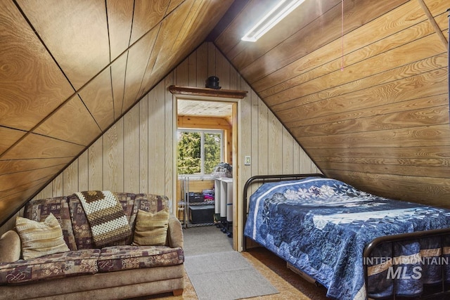 carpeted bedroom with wooden walls, vaulted ceiling, and wood ceiling