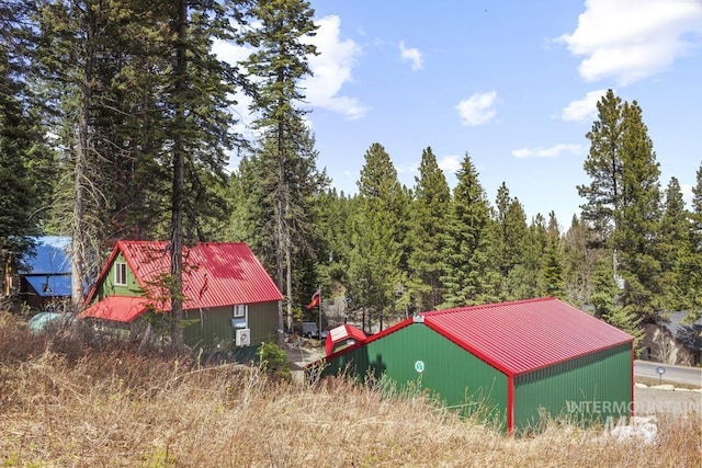 exterior space featuring a wooded view