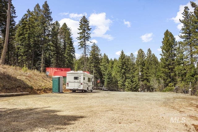 view of yard with a view of trees