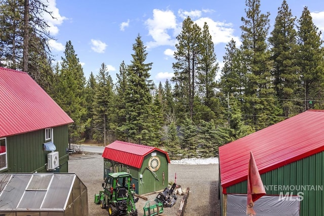 exterior space with a view of trees and an outdoor structure