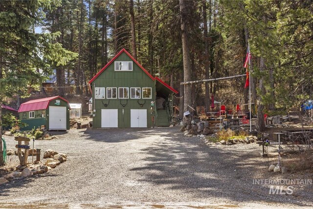 view of front of property with a shed and an outbuilding
