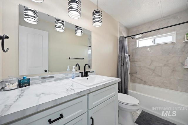 bathroom with toilet, shower / bath combination with curtain, and vanity