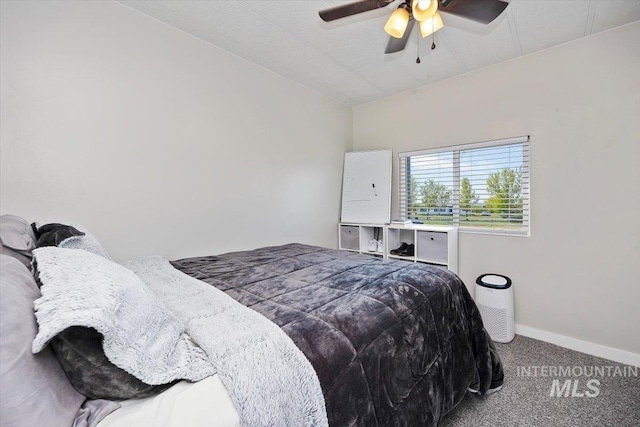 carpeted bedroom with baseboards and a ceiling fan