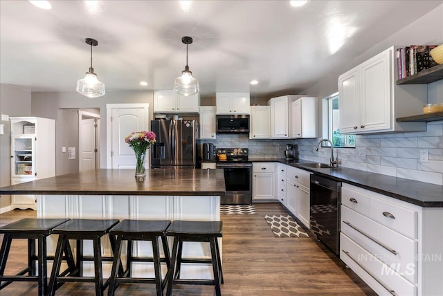 4076 N 3446 E, Kimberly, ID 83341 - kitchen featuring appliances with stainless steel finishes, open shelves, white cabinetry, tasteful backsplash, and a center island