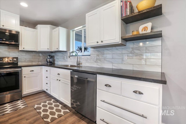 4076 N 3446 E, Kimberly, ID 83341 - kitchen featuring stainless steel appliances, open shelves, dark wood-style floors, decorative backsplash, and dark countertops