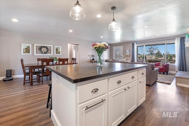 4076 N 3446 E, Kimberly, ID 83341 - kitchen with open floor plan, dark wood finished floors, recessed lighting, white cabinetry, and a kitchen island