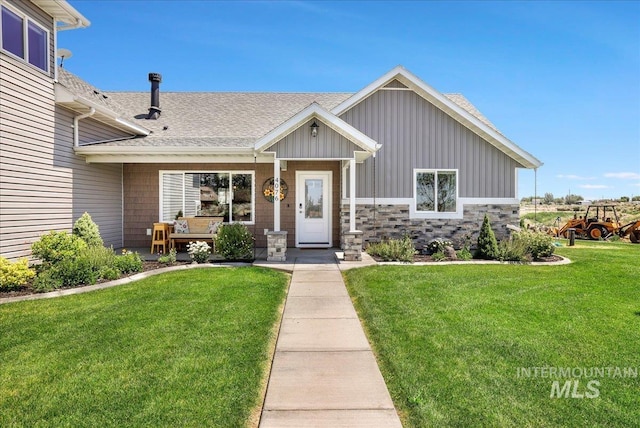 4076 N 3446 E, Kimberly, ID 83341 - view of front of house featuring board and batten siding, a front yard, and roof with shingles
