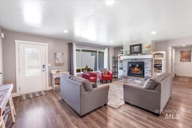4076 N 3446 E, Kimberly, ID 83341 - living room featuring wood finished floors, plenty of natural light, a stone fireplace, and recessed lighting