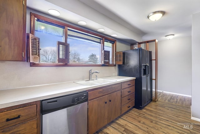 620 Monte Vista Dr, Twin Falls, ID 83301 - kitchen with black fridge, dishwasher, a sink, light countertops, and dark wood finished floors