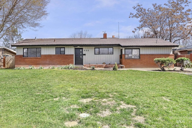 620 Monte Vista Dr, Twin Falls, ID 83301 - ranch-style home with brick siding, a chimney, fence, and a front lawn