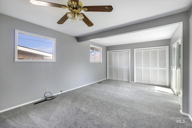 620 Monte Vista Dr, Twin Falls, ID 83301 - unfurnished bedroom with baseboards, a ceiling fan, carpet floors, visible vents, and multiple closets
