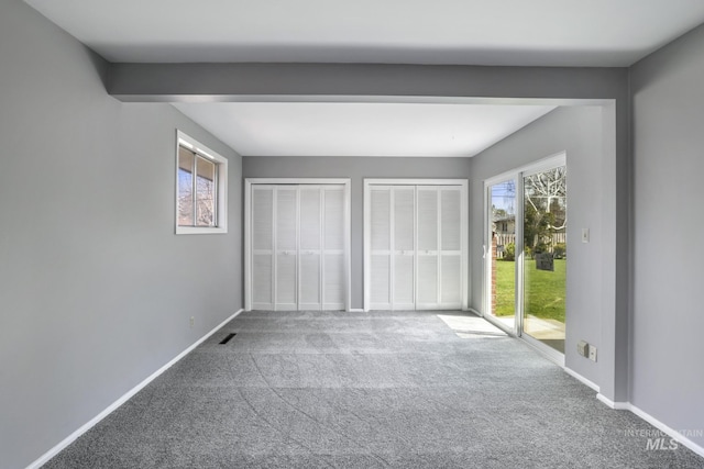 620 Monte Vista Dr, Twin Falls, ID 83301 - unfurnished bedroom with visible vents, access to exterior, carpet, and two closets