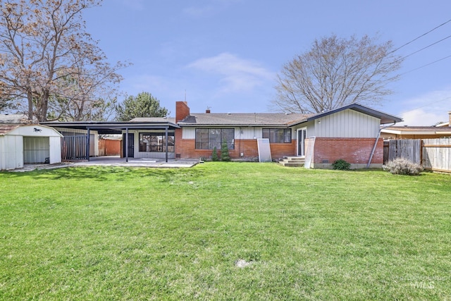 620 Monte Vista Dr, Twin Falls, ID 83301 - back of house featuring brick siding, entry steps, fence, and a yard