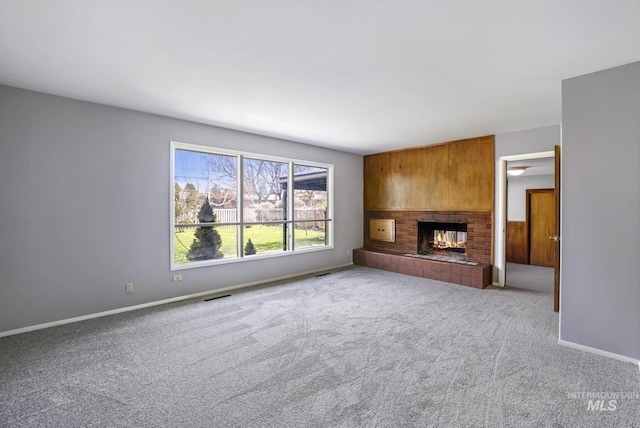 620 Monte Vista Dr, Twin Falls, ID 83301 - unfurnished living room featuring a brick fireplace, baseboards, visible vents, and carpet floors