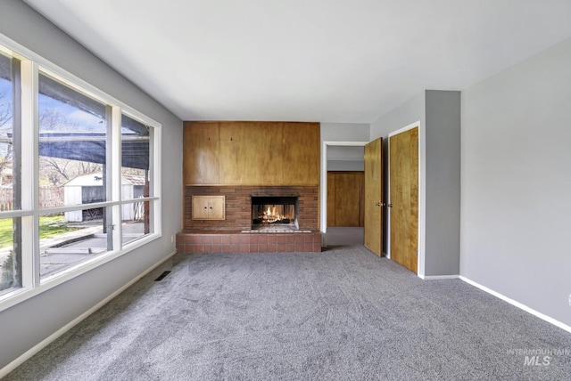 620 Monte Vista Dr, Twin Falls, ID 83301 - unfurnished living room with carpet, visible vents, a lit fireplace, and baseboards