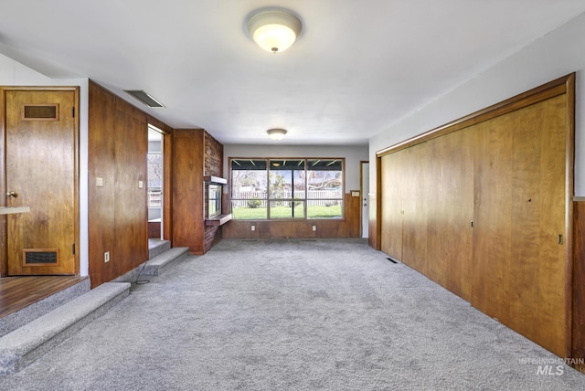 620 Monte Vista Dr, Twin Falls, ID 83301 - spare room with carpet, visible vents, and wooden walls