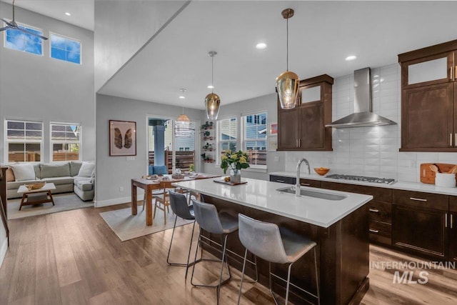 2959 S Shady Ln, Boise, ID 83716 - kitchen with wall chimney exhaust hood, a sink, light countertops, healthy amount of natural light, and recessed lighting