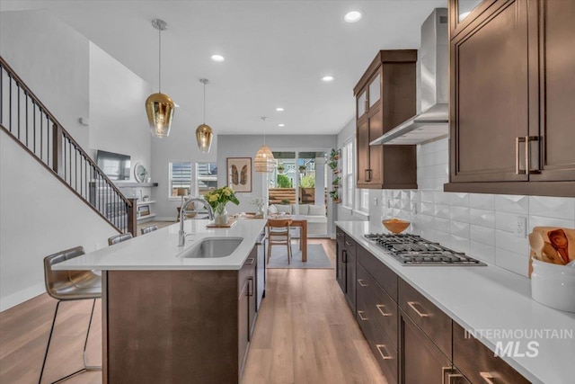 2959 S Shady Ln, Boise, ID 83716 - kitchen featuring wall chimney exhaust hood, a sink, light wood finished floors, light countertops, and recessed lighting
