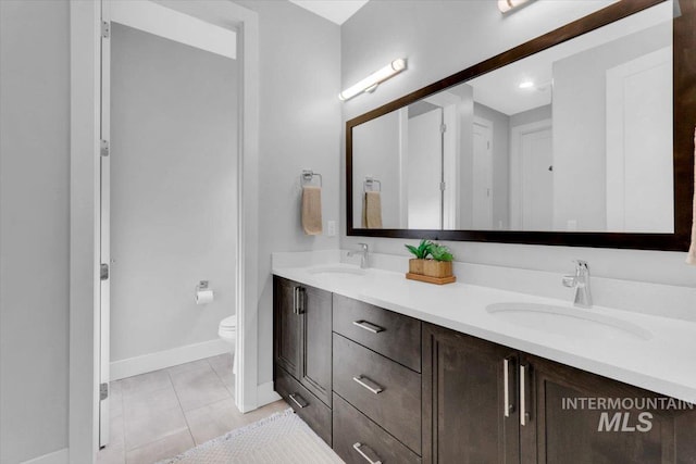 2959 S Shady Ln, Boise, ID 83716 - bathroom featuring double vanity, baseboards, tile patterned flooring, and toilet